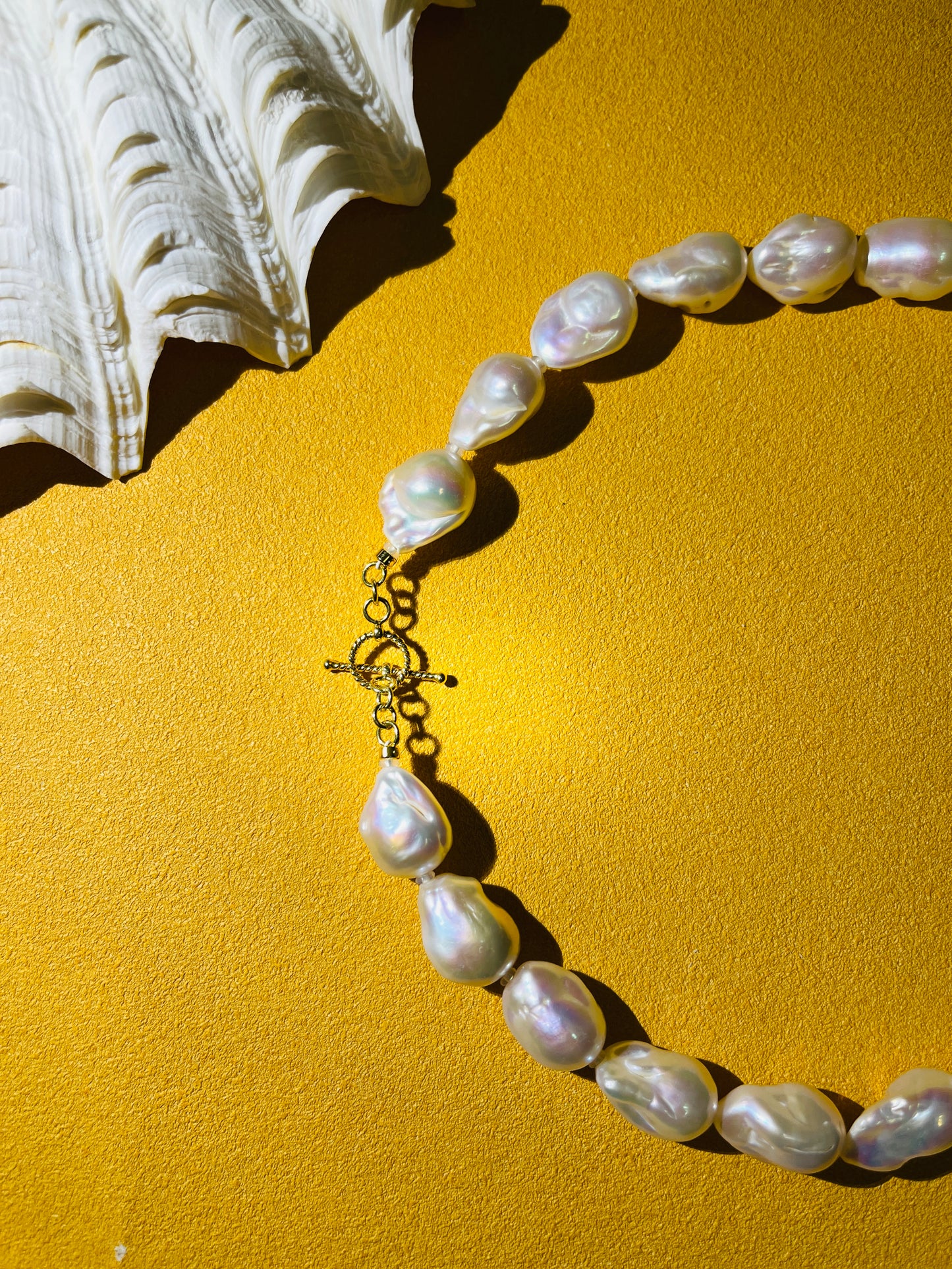 Baroque Pearl necklace on a yellow background