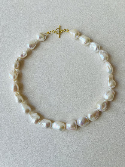 Pearl necklace on a light gray background