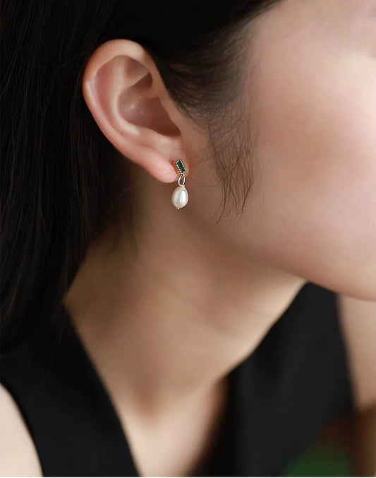 Pearl earring worn by a person with a blurred background