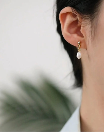 Pearl earring worn by a person with a blurred background