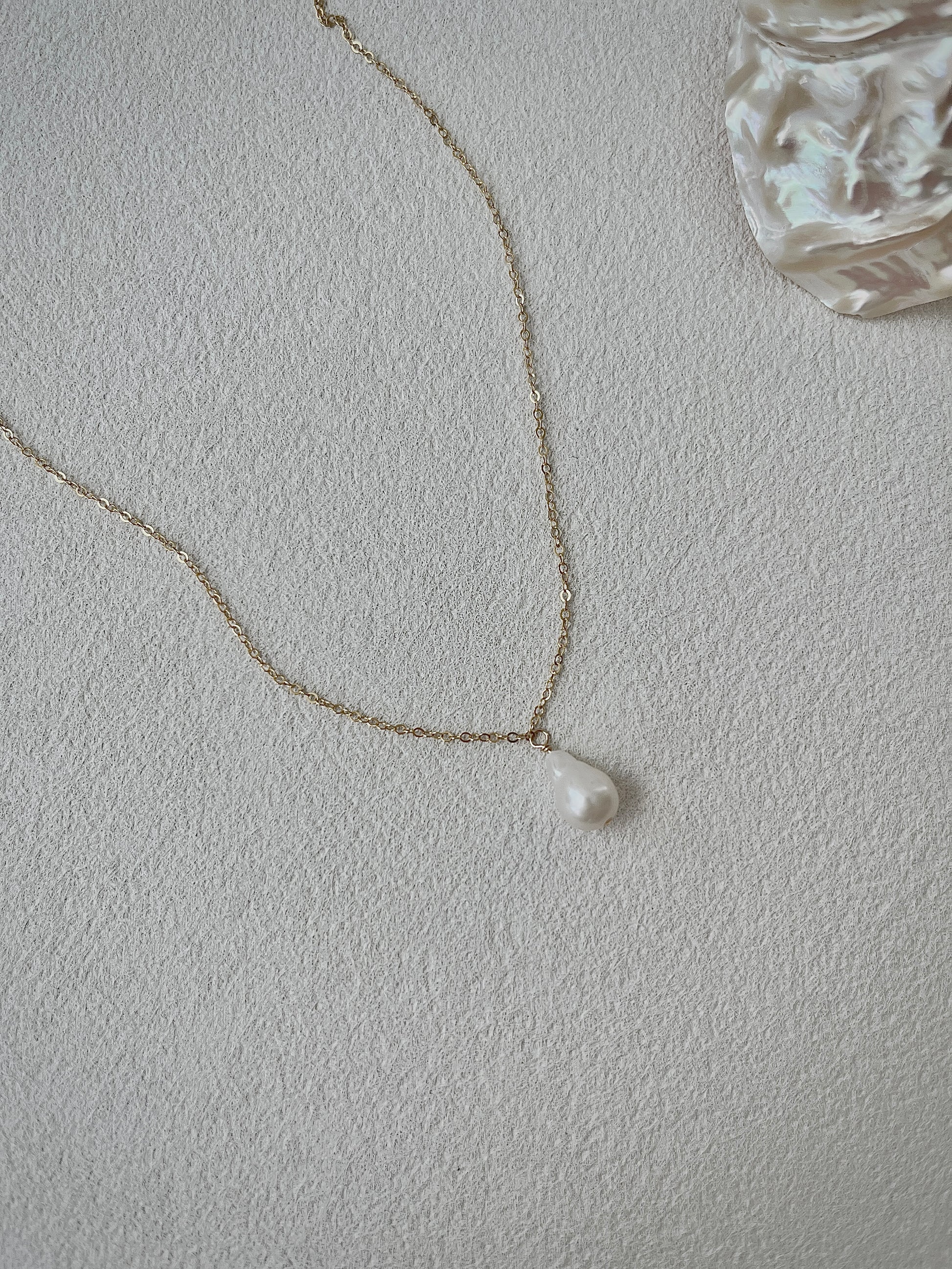 Pearl necklace on a light gray background